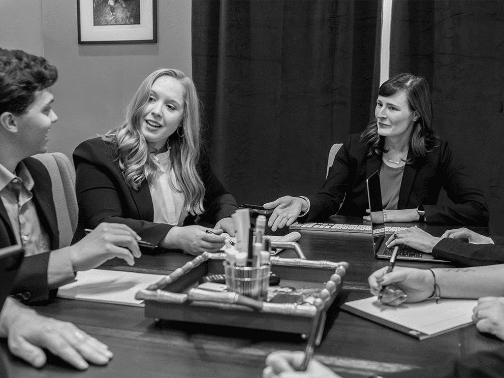 Script Marketing team members sitting around a conference table discussing plans for building product industries clients.